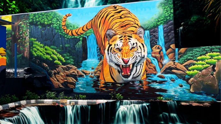 Realistic 3D wall mural of a roaring tiger emerging from a jungle waterfall, painted in vibrant colors with rocks, greenery, and flowing water by Cedar Creative Art.